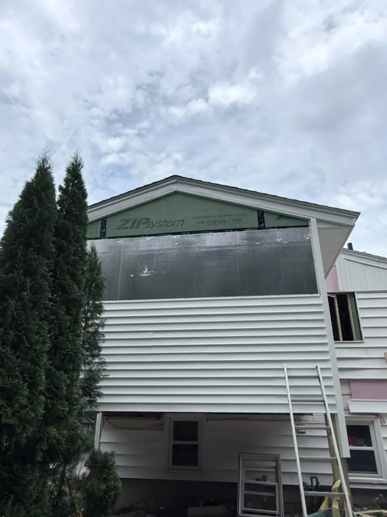 Rigid insulation board going on over the sheathing before the siding