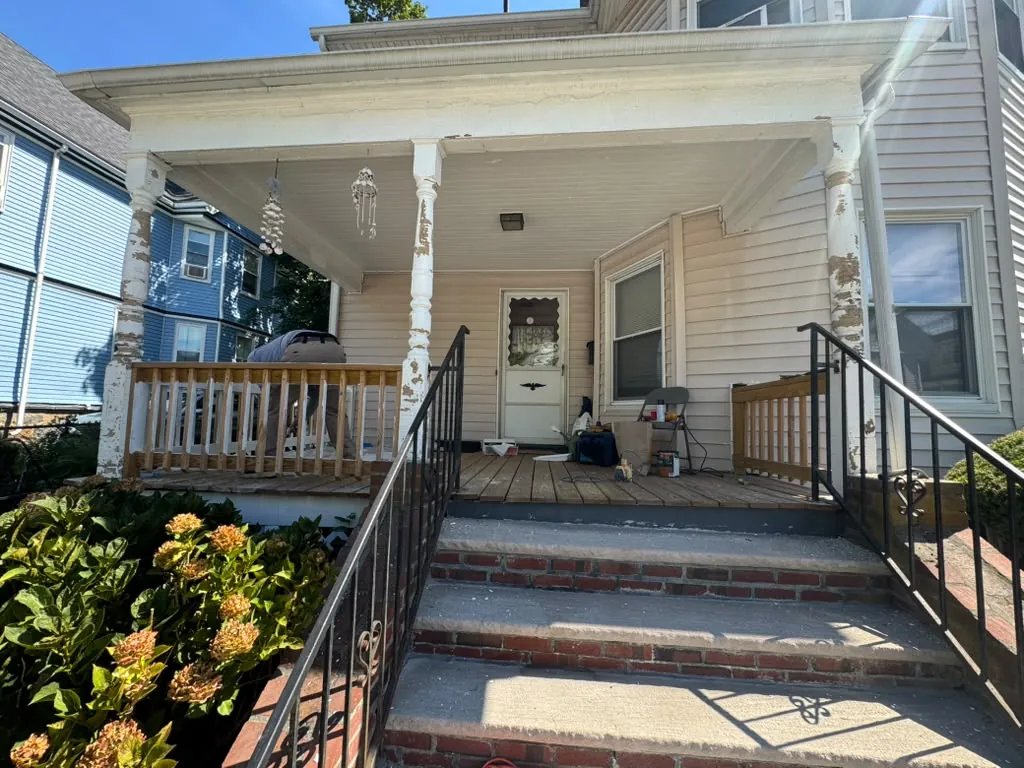 New railing going in on the porch while the old columns are still stripped back