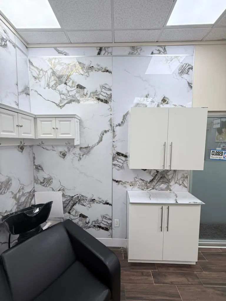 Salon wall cabinets and counter, with the porcelain panels carried up the full height