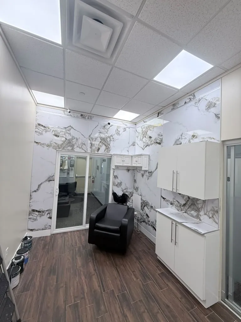 Corner of the salon with the wash chair, wall cabinets and the porcelain panelling behind