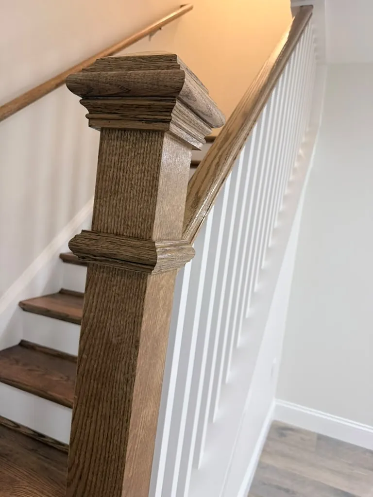 Detail of the oak newel cap and the handrail joint