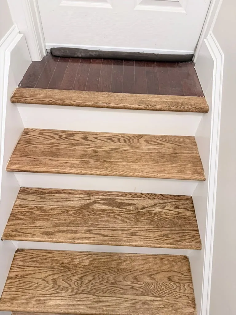 Close view of the oak treads and painted risers at the top of the run